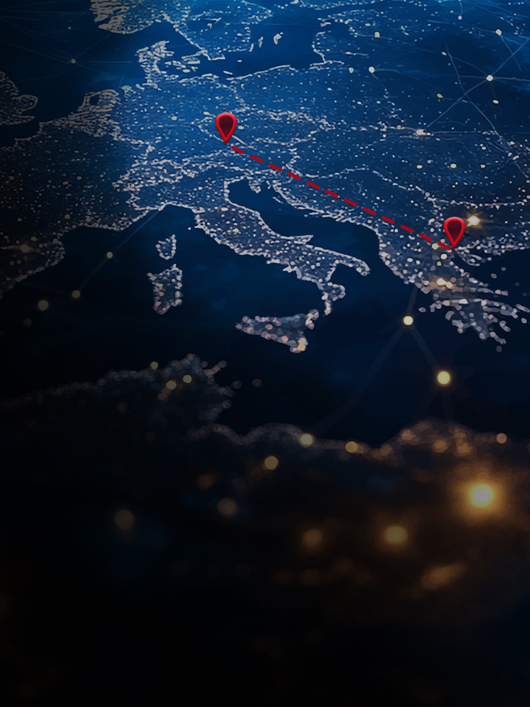 Satellite image of Europe at night with two red markers and a dashed line connecting Landau an der Isar and Thessaloniki.